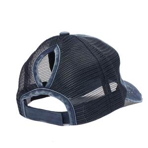 Detail view of washed denim ponytail baseball cap with breathable mesh back and velcro strap