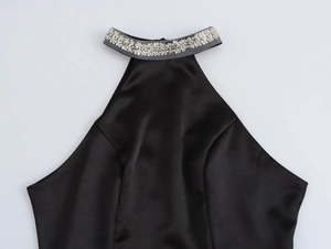 Detailed view of black satin halter neckline with shimmering silver rhinestone embellishments