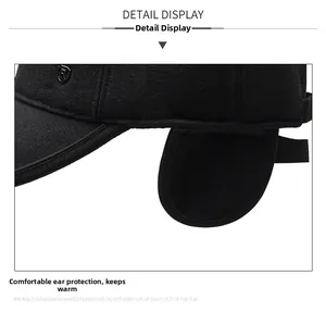 Detail of warm winter baseball cap with ear flaps and thick black wool fabric texture