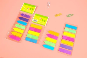 Close-up of arrow and rectangle neon PET index tabs on clean pink background
