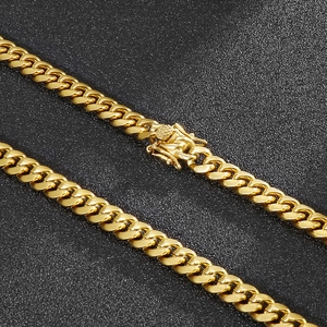 Golden 8mm Cuban link chain necklace with detailed embossed box clasp on black background