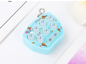 Detail of blue mini whack-a-mole game keychain with seven buttons on a desk