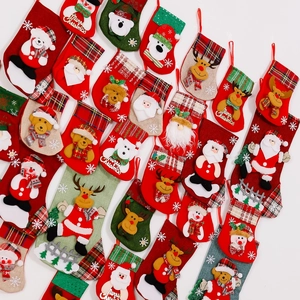 Close-up of various mini Christmas stockings featuring felt applique and festive patterns
