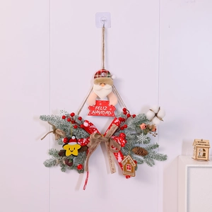Detail of Christmas wreath with Santa Claus, pine branches, and Feliz Navidad sign