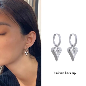 Polished silver heart drop earrings shown on model and in close-up product detail