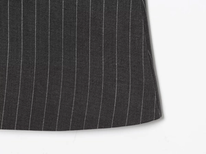 Close-up of black pinstripe fabric showing fine texture and quality stitching details