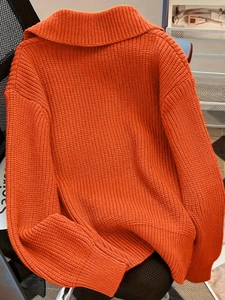 Oversized orange chunky knit sweater with wide lapel collar and drop shoulder design