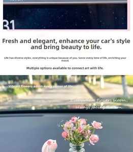Miniature white rabbit resin ornament and glass vase with pink flowers on car dashboard