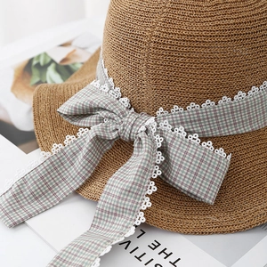 Women's woven straw sun hat with plaid ribbon bow and lace trim for beach vacations
