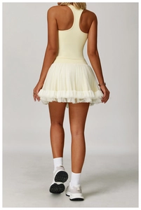 Detail view of the yellow racerback tank top and tiered tulle skirt sport set