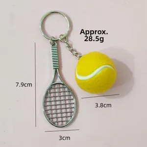 Detailed view of sports keychain with dimensions of tennis racket and ball charms