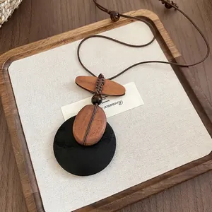 Vintage ethnic style long necklace with wood beads and oval shell pendant on wood tray
