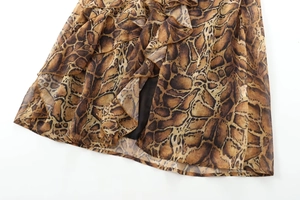 Close-up of brown animal print midi dress showing tiered ruffle hem and chiffon texture
