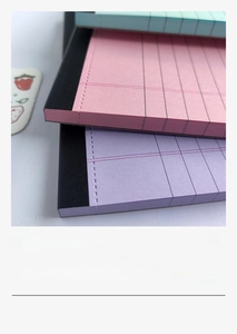 Close-up of pastel legal pads with tear-off lines and neat purple ruled pages