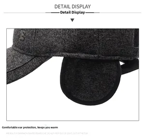 Detail view of winter baseball cap with side ear flaps and metal letter B decoration