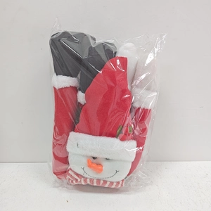 Detailed view of plush Christmas snowman and black boots in clear plastic packaging
