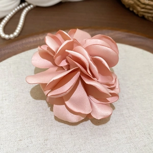 Makro-Detail des eleganten Ringes aus rosa Seidenstoffblumen mit weicher Satinstruktur
