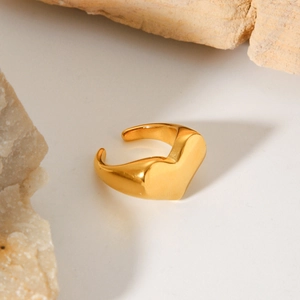 Elegant gold plated minimalist heart-shaped open ring on natural stone background