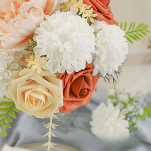 Close-up of vintage foam roses and hydrangeas in dusty pink and terracotta tones