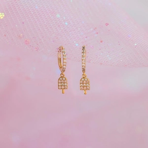 Detail of gold ice cream earrings with pink and white cubic zirconia pave crystals