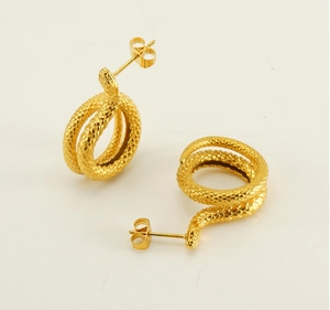 Detailed view of snake-shaped gold earrings with intricate bionic scale texture design
