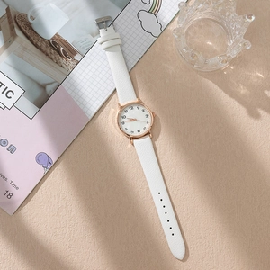 Minimalist women quartz watch with white leather strap and rose gold case on aesthetic background