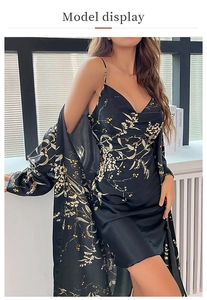 Detail of elegant black satin robe set with white floral and yellow berry prints