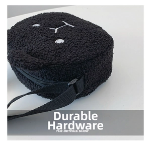 Detail of cute black plush puppy shoulder bag showing soft faux fur texture and zipper