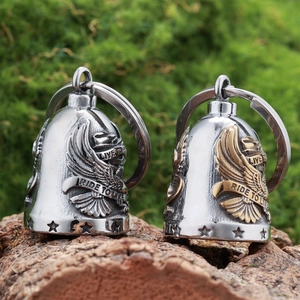 Detailed close-up of eagle motorcycle guardian bells in silver and gold finish