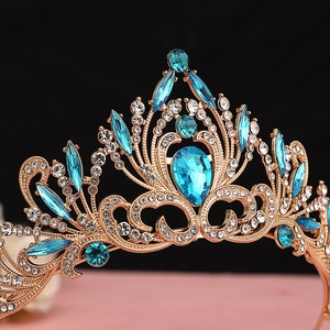 Detailed macro view of vintage gold bridal crown featuring blue teardrop crystals and jewels