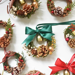 Handmade Christmas mini wreaths with pinecones, berries, bells and festive ribbon ties