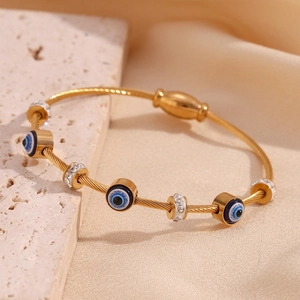 Detail of 18K gold-plated cable bracelet with evil eye charms and sparkling pavé beads