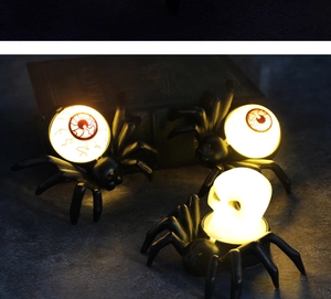 Close-up of Halloween LED spider lamps with glowing skull and eyeball lights for spooky decor