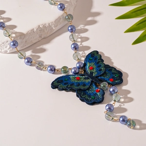 Retro embroidered blue butterfly necklace with diamond accents and glass beads