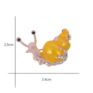 Detail showing cartoon snail brooch dimensions with yellow enamel and rhinestones