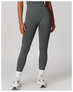 Detail of high-waist seamless compression yoga pants with matte texture in dark grey