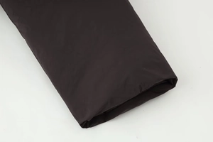 Detail shot of black windproof sleeve cuff with high-quality stitching and matte texture