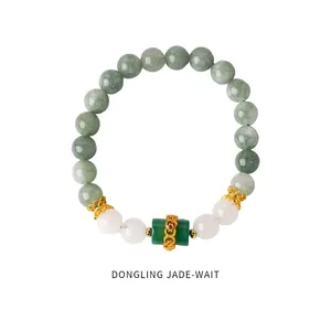 Detailed shot of aventurine jade beaded bracelet with golden filigree and red zircon