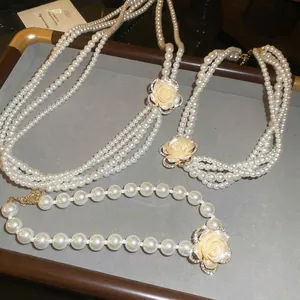 Multi-layer pearl necklace set with elegant diamond-encrusted rose floral pendants