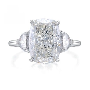 Detailed macro shot of cushion cut gemstone with half moon side diamonds on silver ring