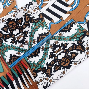 Close-up of ethnic colorful faux silk scarf featuring detailed abstract geometric patterns