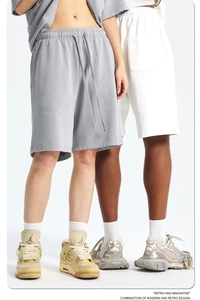 Close-up of drawstring waistbands on grey and white cotton retro athletic shorts
