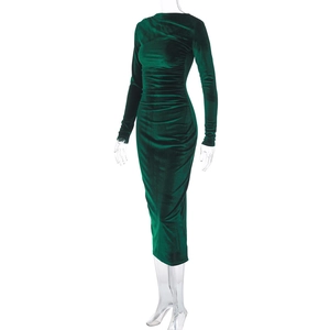 Detail of dark green velvet dress showing slim fit ruching and soft fabric texture