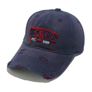 Close-up of vintage NEW YORK embroidery and distressed details on a navy baseball cap