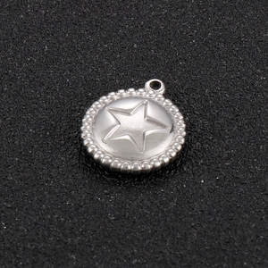 Macro view of a silver stainless steel circular star pendant with beaded edge detail