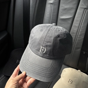 Close-up of washed cotton baseball cap featuring embroidered logo and reinforced stitching