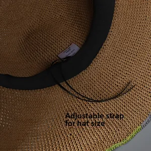 Detail view of woven paper straw sun hat featuring adjustable inner black drawstring