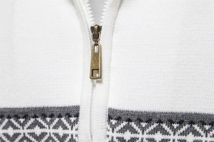 Detail of half-zip sweater with bronze metal zipper and grey geometric knit texture