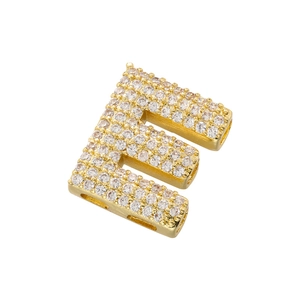 Detail view of gold letter E pendant with sparkling micro-paved cubic zirconia stones