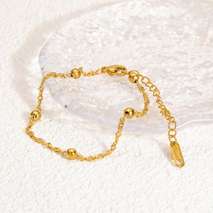 Elegant 18K gold plated stainless steel bead chain bracelet on a glass tray
